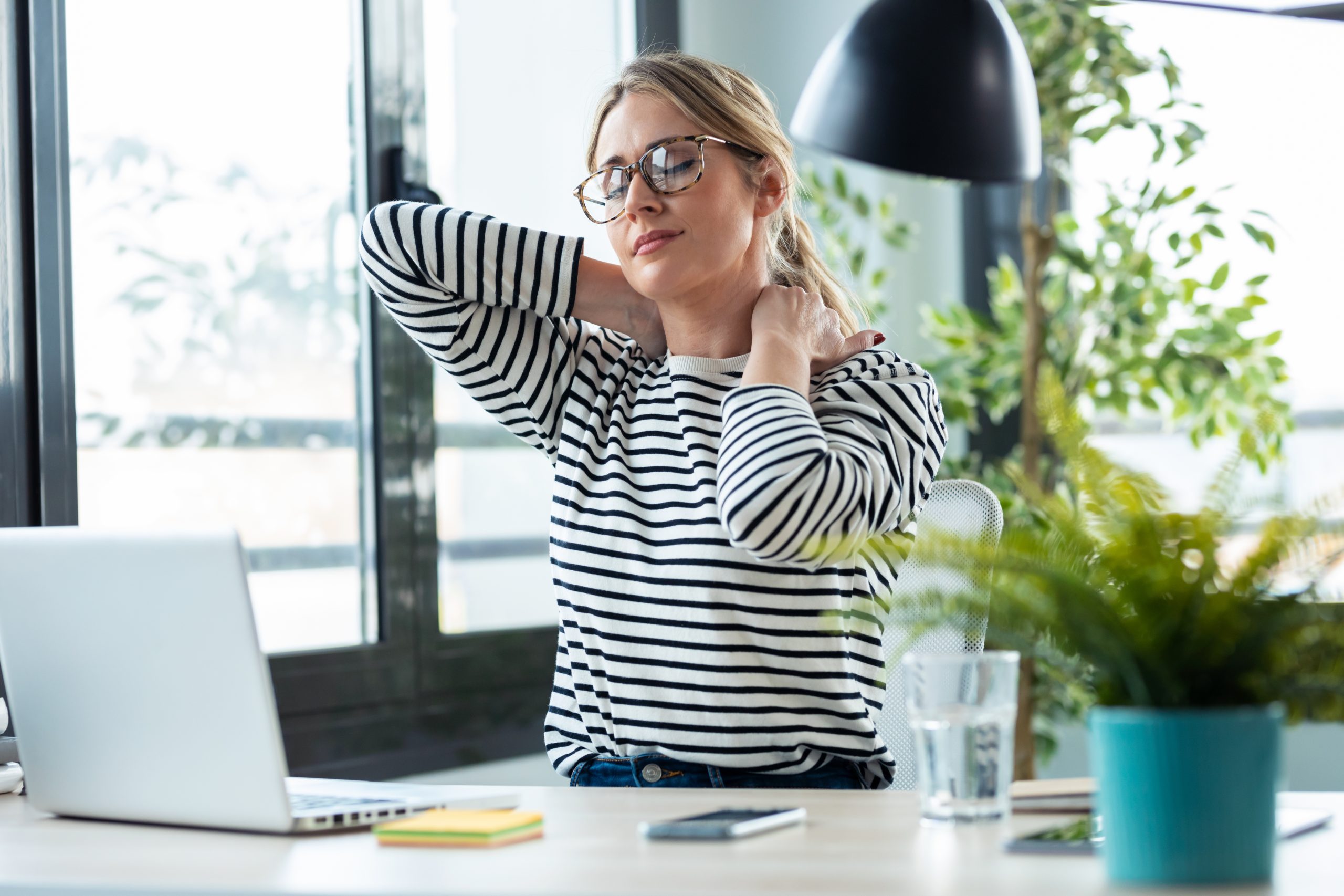 Shot,Of,Tired,Mature,Business,Woman,With,Neck,Pain,Looking